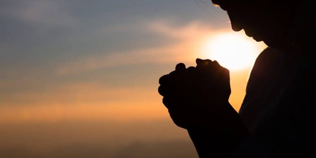 Religious young woman praying to God in the morning, spirtuality and religion, Religious concepts